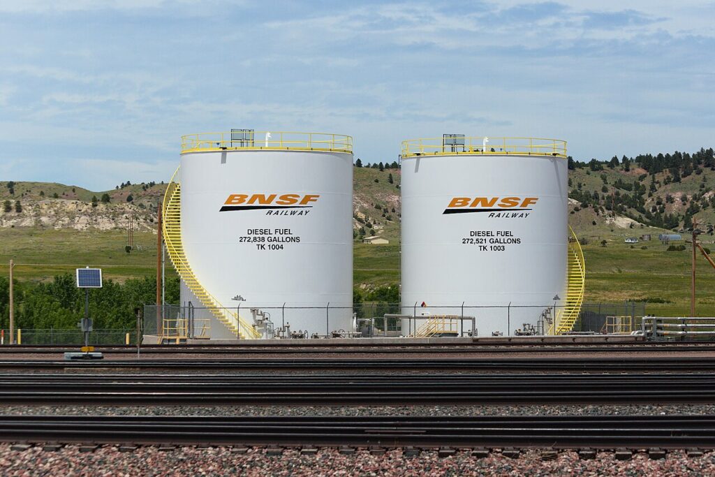 Generator Fuel Consumption and Running Costs Two large vertical diesel fuel storage tanks at a rail facility