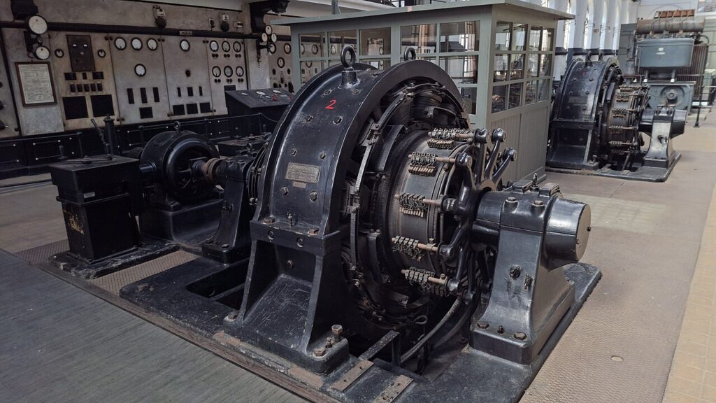 How to Read a Generator Specification Sheet Historic electrical generator with an instrumented control panel of round gauges in a power station