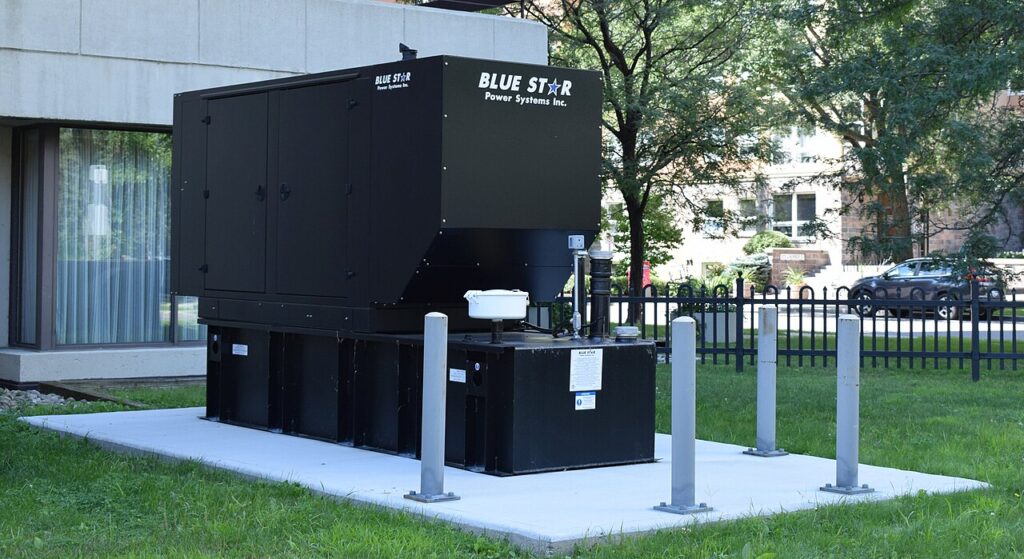 Why Buyers Prefer Silent Generator Sets in 2026 Standby diesel generator with sound-attenuated enclosure beside a building