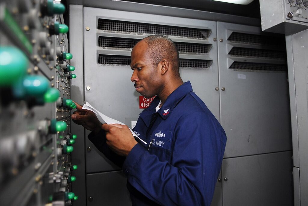 Essential Generator Maintenance Checklist Technician performing preventive maintenance on a generator control panel